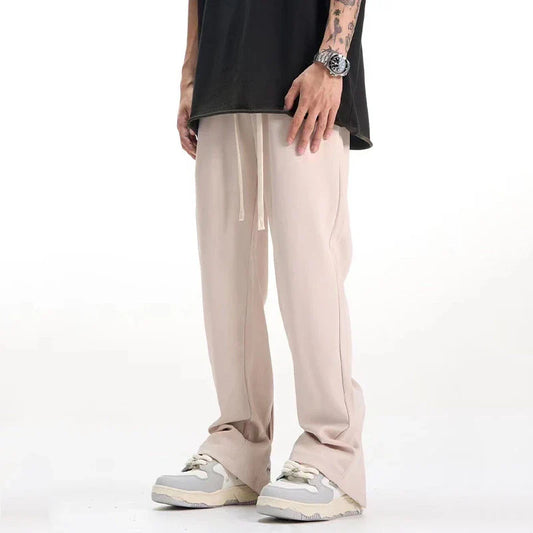 Sophisticated retro-style casual suit trousers in black and apricot colours, featuring a sleek straight-leg silhouette and distinctive back slit