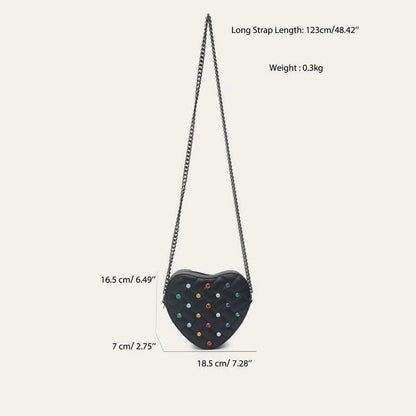 A stylish heart-shaped vegan leather crossbody bag with colourful rhinestone detailing, a versatile and fashionable accessory.