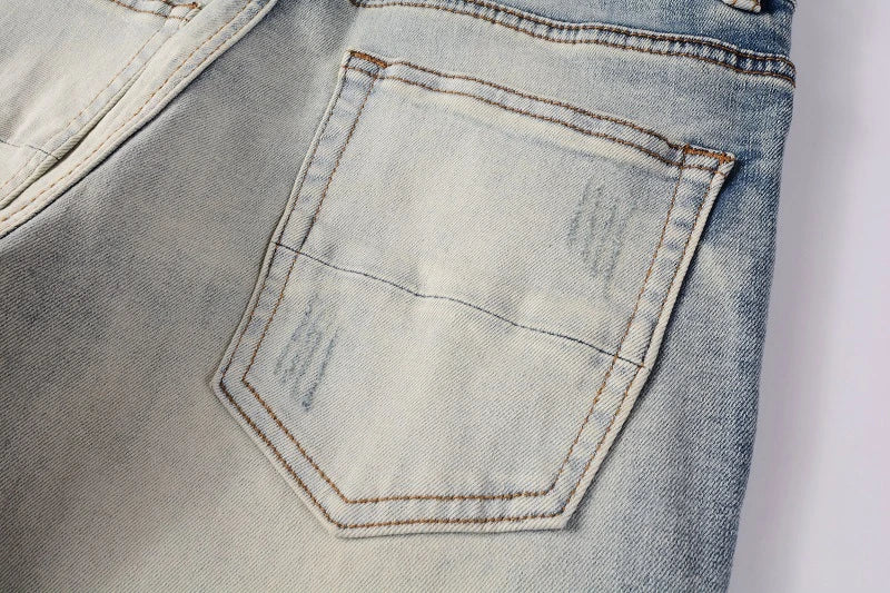 Stylish distressed denim jeans with a skinny, knee-exposed silhouette for a contemporary, high-street fashion look