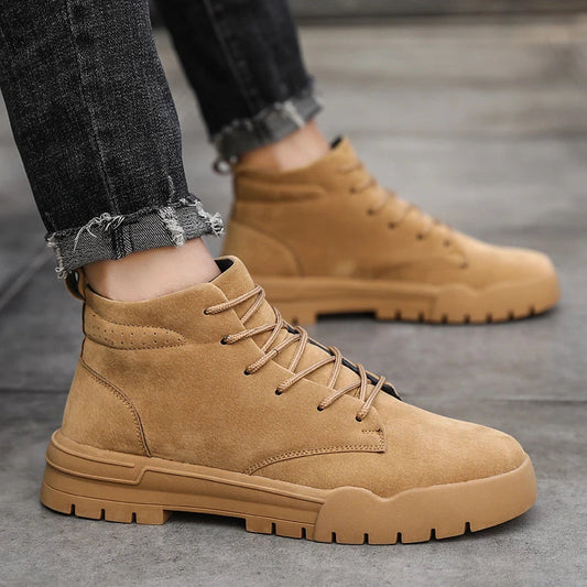 A pair of high-quality suede Martin boots with a rubber sole, showcasing the timeless British-inspired design.