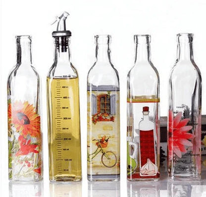 Ethnic-inspired glass bottles with handpainted floral designs, offering stylish storage for sauces, oils, and spices