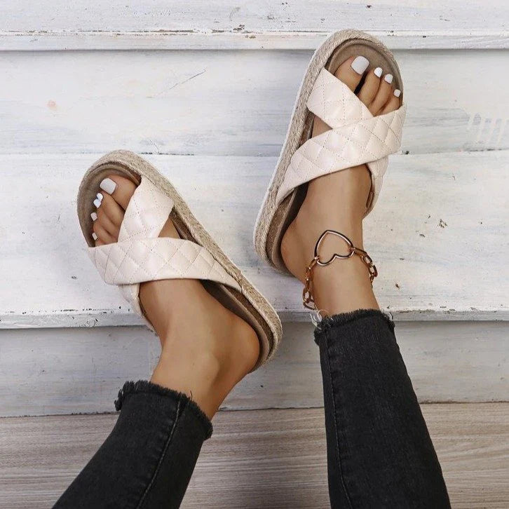 Elegant cross-toe platform sandals and slippers in a neutral creamy white hue, showcasing a contemporary and refined design for the discerning woman