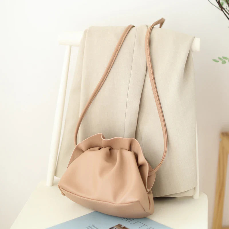 Stylish retro dumpling bag in premium PU material with one-shoulder design and adjustable strap, available in classic British colours