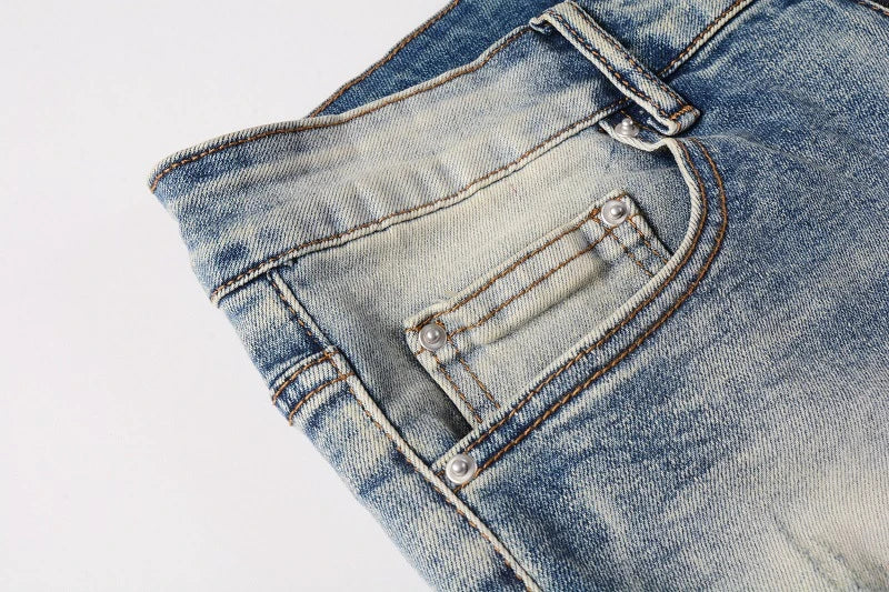 Stylish distressed denim jeans with a skinny, knee-exposed silhouette for a contemporary, high-street fashion look
