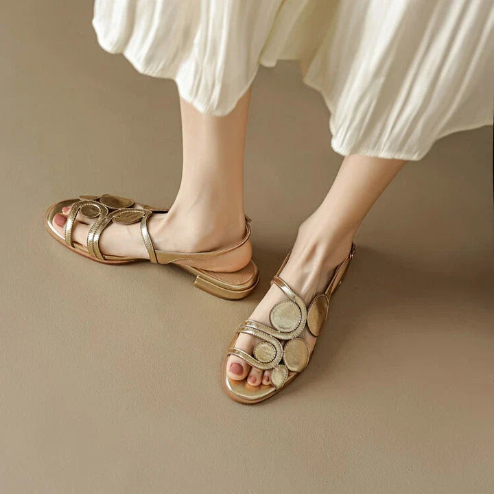 Chic sheepskin round toe sandals with a chunky heel and hollow out design, featuring a secure back strap and a modern, versatile style