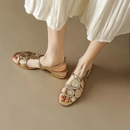 Chic sheepskin round toe sandals with a chunky heel and hollow out design, featuring a secure back strap and a modern, versatile style