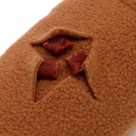A plush snail-shaped snuffle mat toy with hidden treat pockets, designed to stimulate a dog's natural foraging instincts.