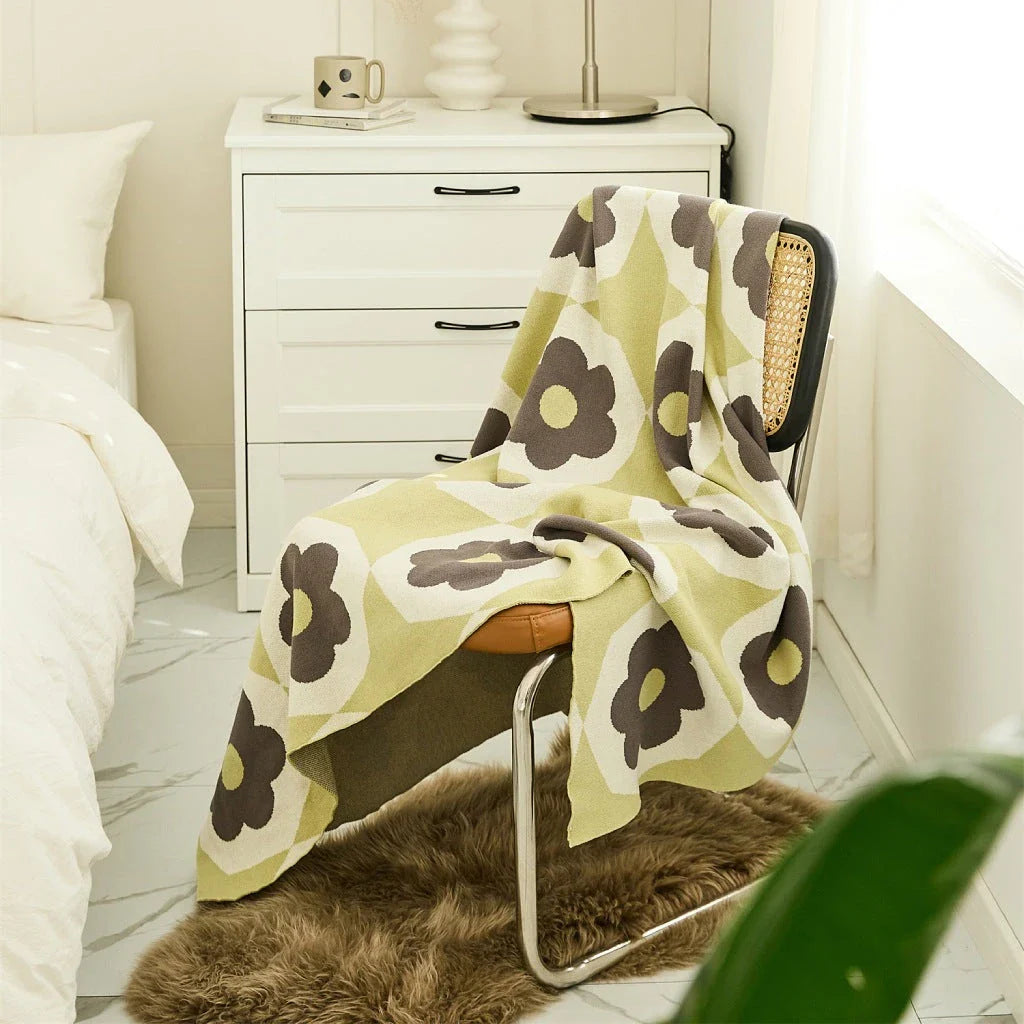 Floral knitted cotton throw blanket in a cosy Matcha Green colour, perfect for British homes and outdoor adventures.