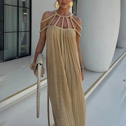 A stylish and sophisticated hollow out knitted beach dress in a beige colour, perfect for summer beach and poolside wear.