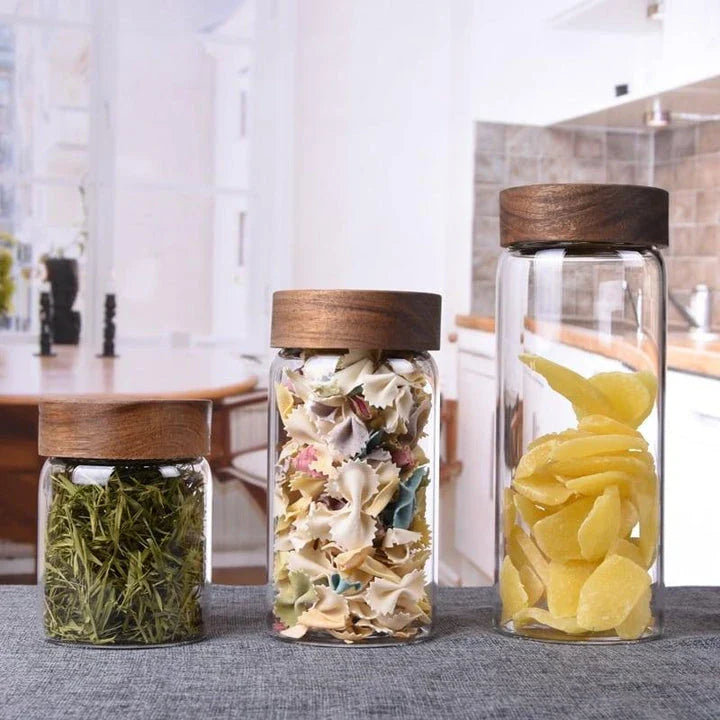Premium glass storage jars with wooden lids in various sizes, designed for stylish and functional kitchen organisation