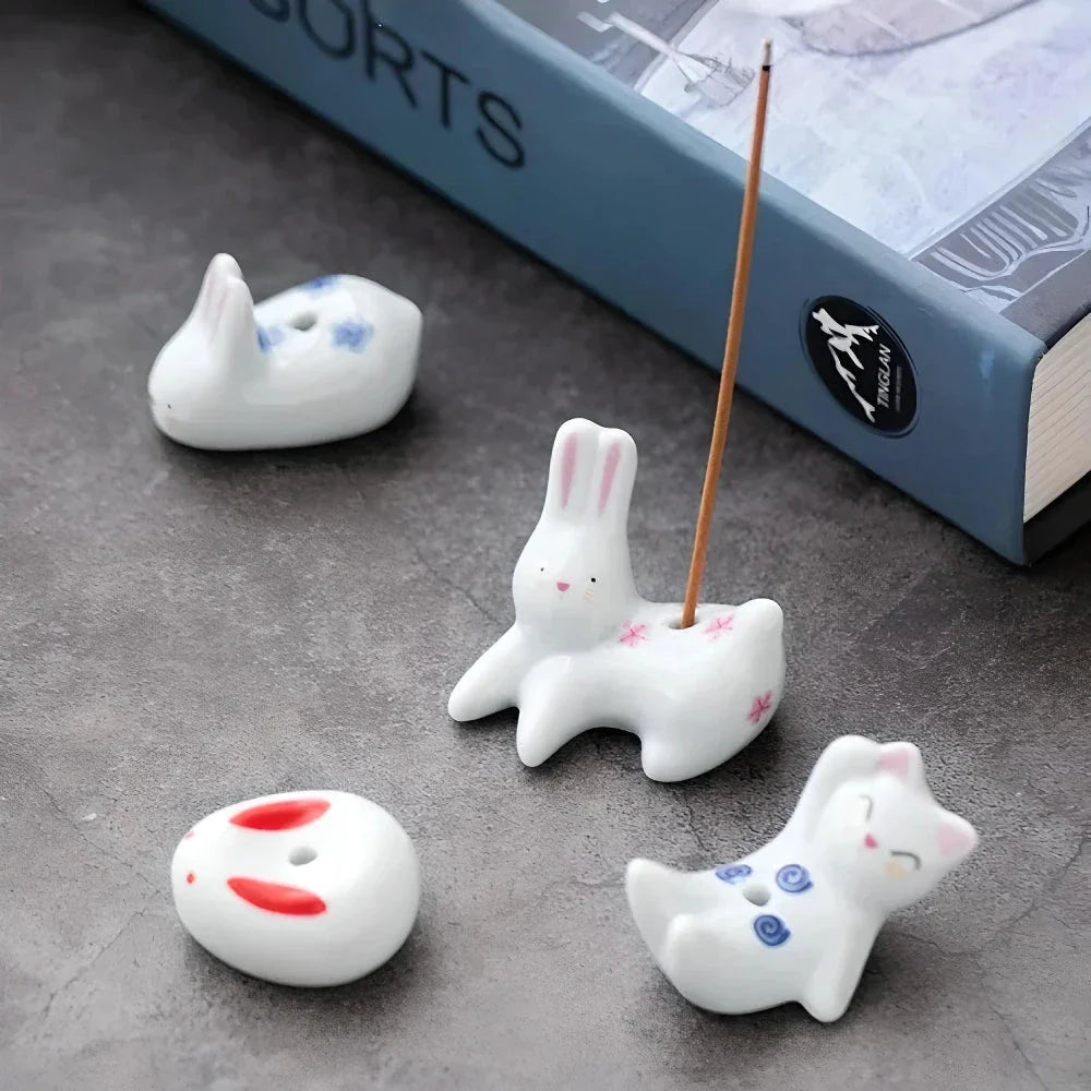 Charming Japanese-style ceramic incense holder with a playful rabbit and kitten design, perfect for creating a relaxing atmosphere in any room.