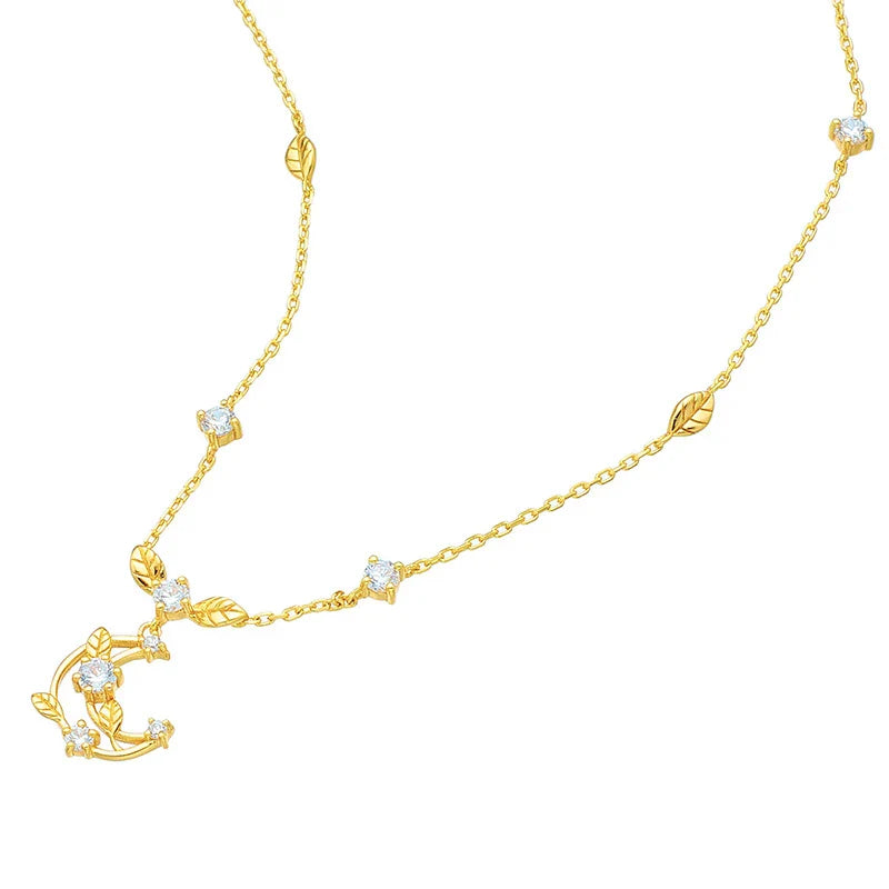 Elegant crescent moon necklace with intricate leaf design in a gleaming gold tone