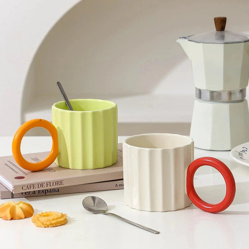 Japanese-style ceramic coffee mug with a unique ripple handle design, perfect for hot and cold beverages