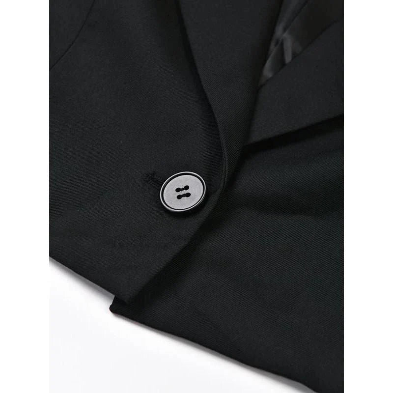 A stylish denim patchwork blazer with a notched collar and single-button closure, designed for the modern British woman