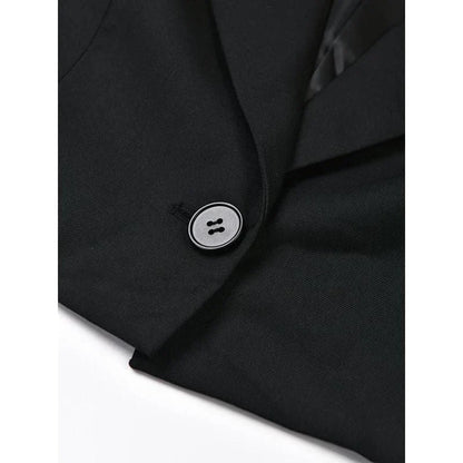 A stylish denim patchwork blazer with a notched collar and single-button closure, designed for the modern British woman