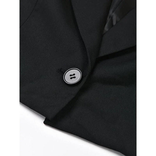 A stylish denim patchwork blazer with a notched collar and single-button closure, designed for the modern British woman