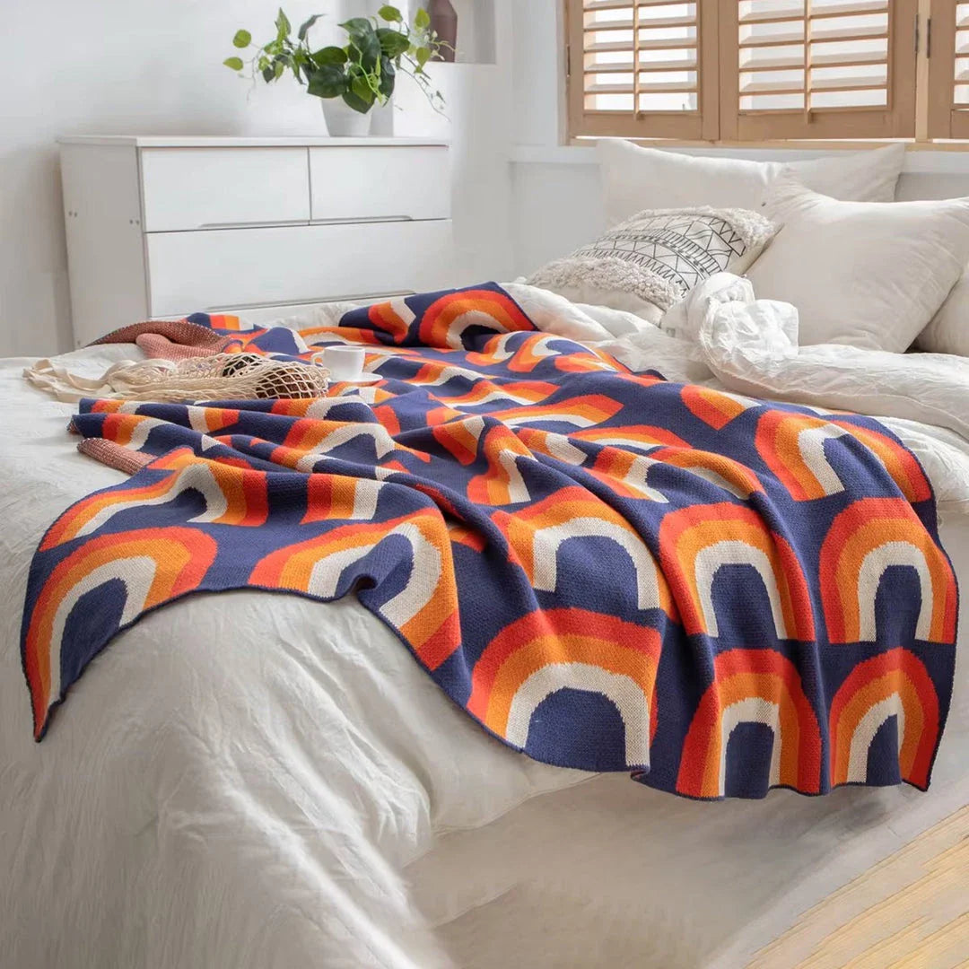 Cosy and vibrant 100% cotton knit throw blanket with a colourful rainbow pattern