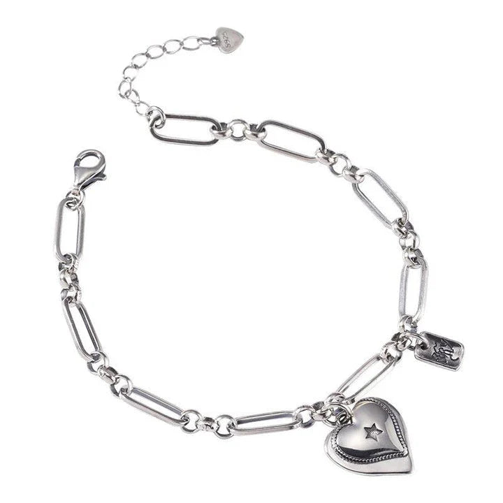 Elegant sterling silver bracelet with a delicate heart charm, a timeless accessory for the modern British woman.