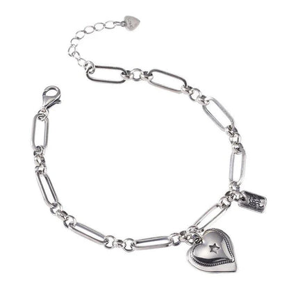 Elegant sterling silver bracelet with a delicate heart charm, a timeless accessory for the modern British woman.