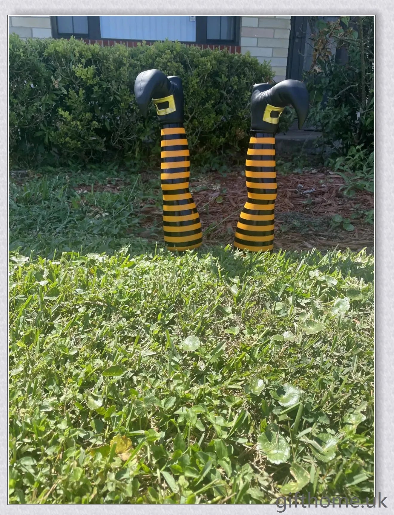 Animated witch legs in various colours, including purple, yellow, and black and white, kicking and moving to create a spooky Halloween display