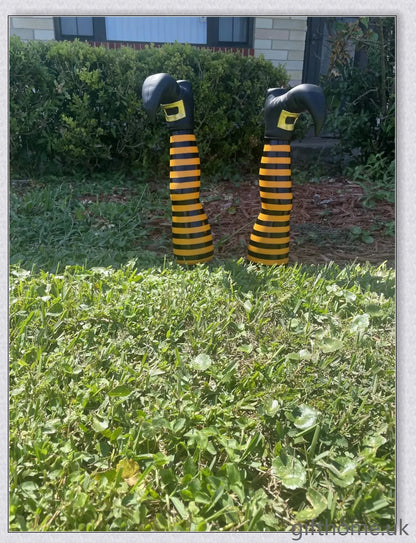 Animated witch legs in various colours, including purple, yellow, and black and white, kicking and moving to create a spooky Halloween display