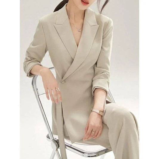 A two-piece vintage-inspired office suit with a long-sleeve blazer and high-waisted trousers, designed for the modern professional woman.