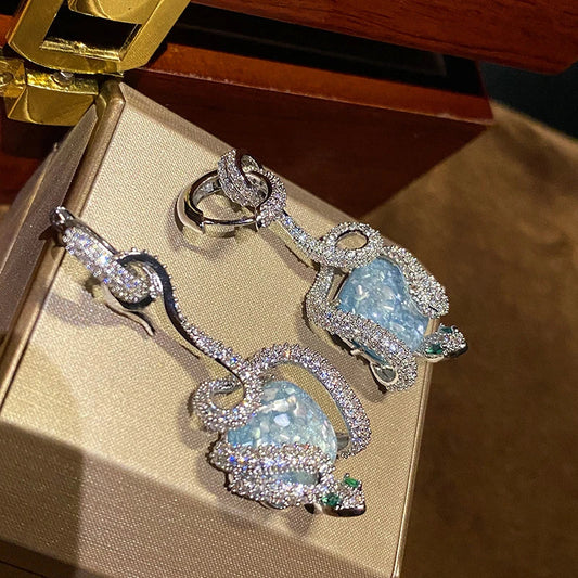 Sophisticated snake-inspired luxury earrings in a copper finish with inlaid gems and semi-precious stones