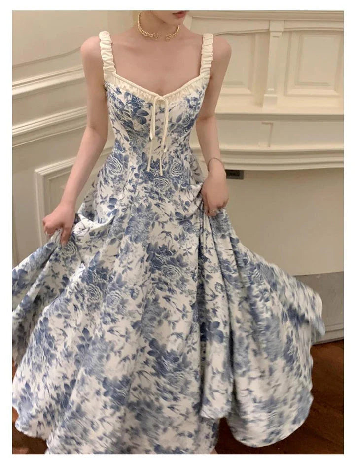 Elegant floral print dress with adjustable straps, A-line silhouette, and high-waisted design for a timeless British fashion look.