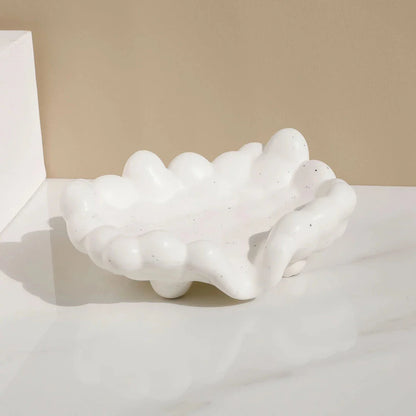 A ceramic soap dish with a whimsical cloud design, perfect for elevating your bathroom decor.