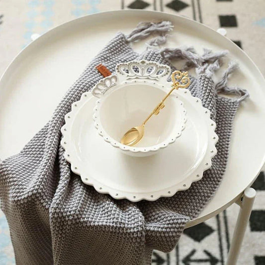 Elegant diamond ring-inspired porcelain dinnerware set with plate, bowl, and cup in a minimalist white colour