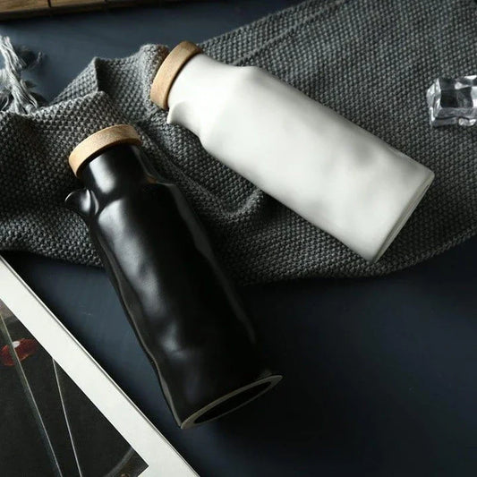 Premium black ceramic oil dispenser with a sleek and modern design, perfect for drizzling oils, vinegars, and sauces in the kitchen.