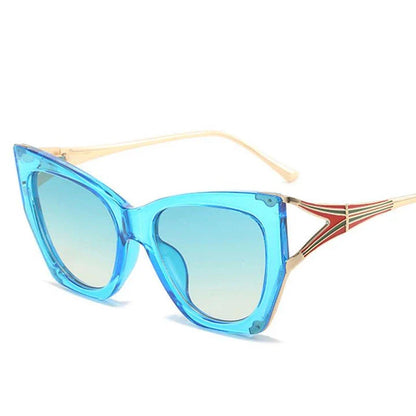 Refined cat eye sunglasses with blue gradient lenses and sleek metal frames, offering timeless British style and UV400 protection.