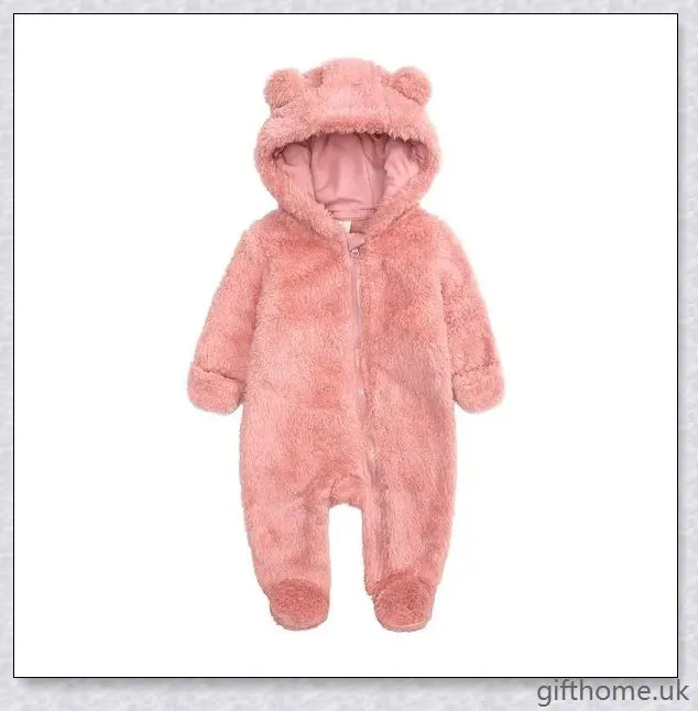 Adorable baby wearing a cosy hooded jumpsuit in blue, pink, or apricot colour