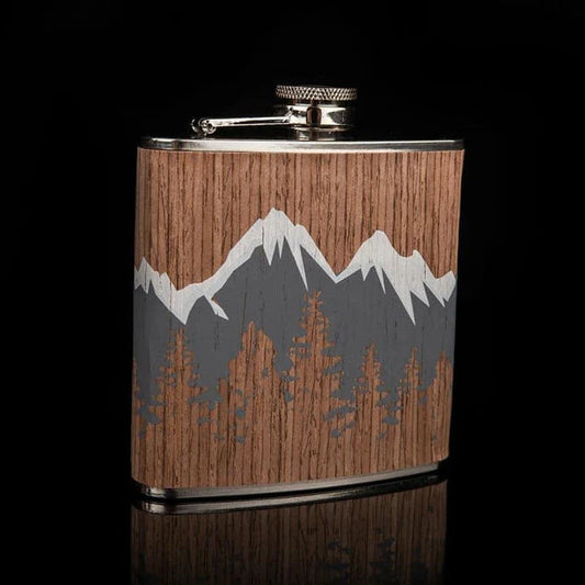 Stylish mountain-themed stainless steel and wood hip flask with optional glasses, perfect for outdoor adventures and social gatherings.