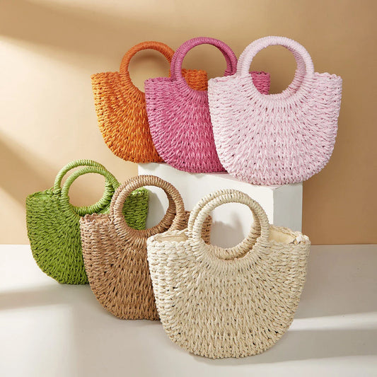 Stylish straw woven women's beach shoulder bag in a half-moon shape, featuring a cotton lining and string closure for a minimalist, bohemian-inspired look.