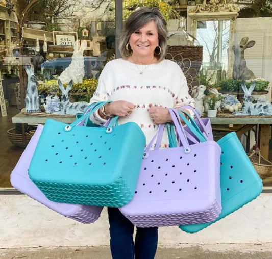 Premium waterproof beach tote bag in various vibrant colours, featuring spacious main compartment and multiple pockets for organised storage