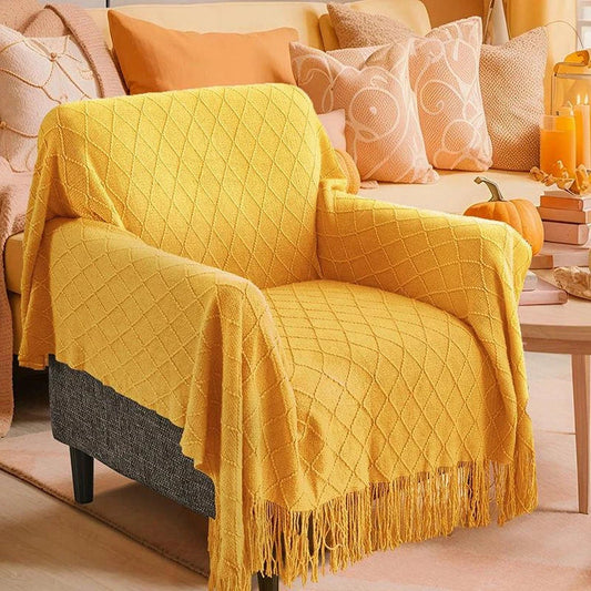 Cosy mustard yellow knitted throw blanket with raised diamond pattern and tassel fringes, providing soft and warm comfort for living rooms, bedrooms, and outdoor use.