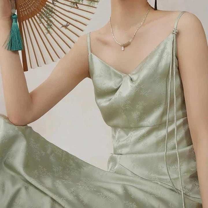 Elegant mint green midi dress with spaghetti straps, featuring a flattering slim fit and beautiful embroidery detailing