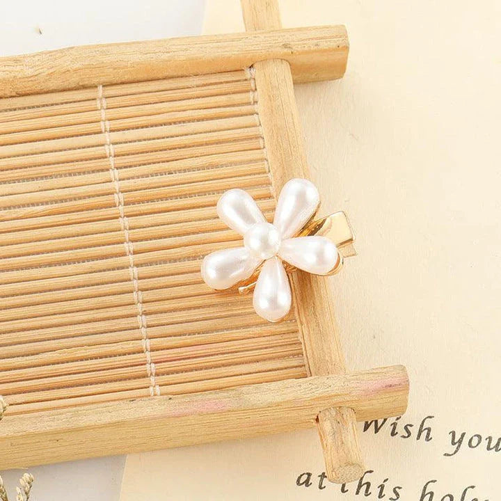 Elegant silver-toned hair clip with a beautiful pearl flower design, a timeless British-inspired accessory