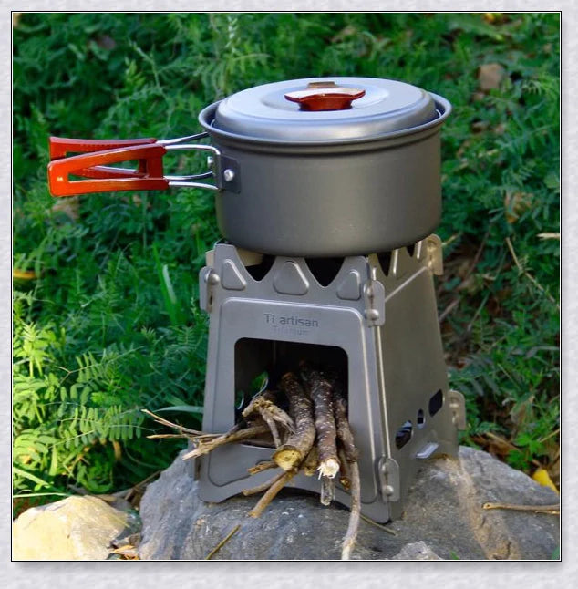 Compact titanium wood-burning camping stove with a folding design and carrying case for easy transport and storage