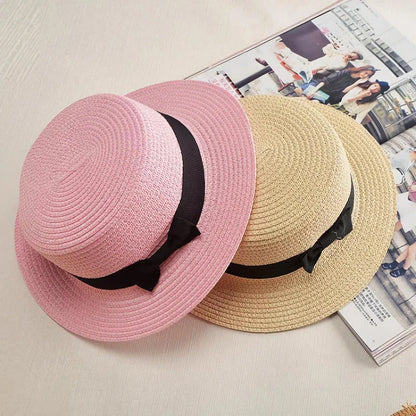A classic summer Panama hat made from straw and paper, featuring a charming bow detail that adds a feminine touch.