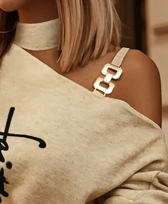 Stylish long sleeve top with diagonal shoulder chain embellishment in black, navy, and burgundy colours