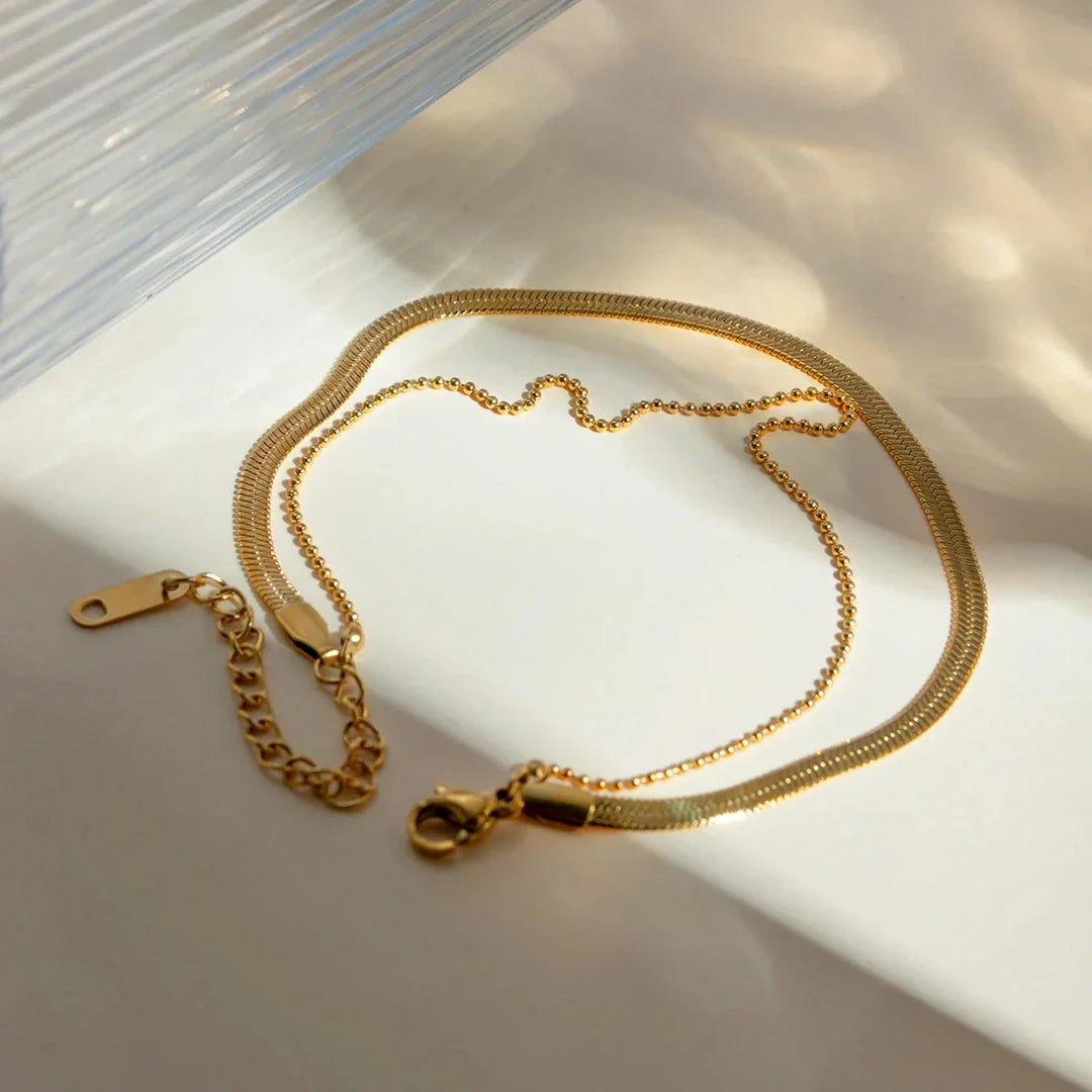 Exquisite 18K gold-plated double layer snake chain anklet with a durable stainless steel base, designed to elevate summer style with timeless elegance.