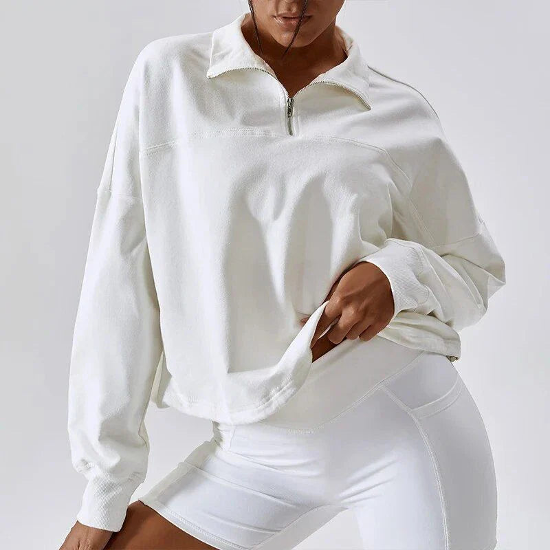 A cosy, oversized cotton pullover with a stylish zipper accent, perfect for casual autumn and winter wear.