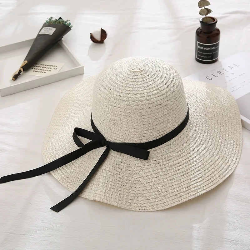 Fashionable straw hat for women with wide brim, foldable design, and stylish bow detail
