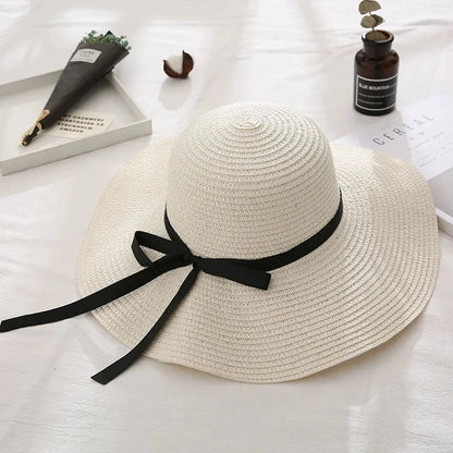 Fashionable straw hat for women with wide brim, foldable design, and stylish bow detail