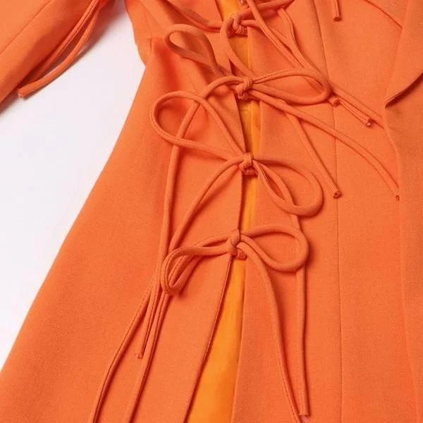 A sophisticated notched collar blazer with an elegant bow detail, perfect for professional and casual wear.