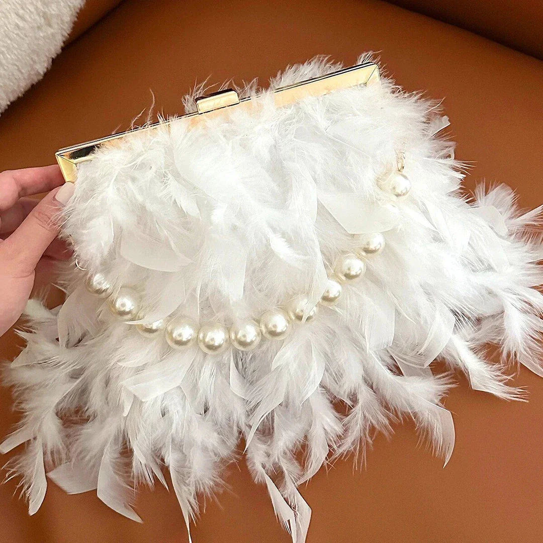 Elegant feather clutch purse with lustrous pearls, metal chains, and a top handle design