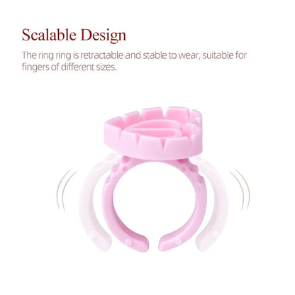 Heart-shaped disposable eyelash glue rings in blue, pink, and white colours