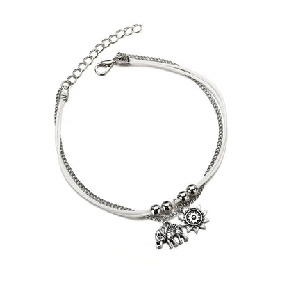 Elegant bohemian-style anklet with star and elephant charms in shimmering gold and silver tones